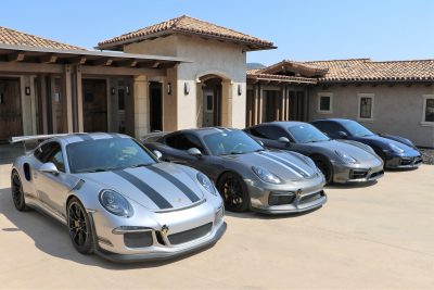 Four silver Porsche cars